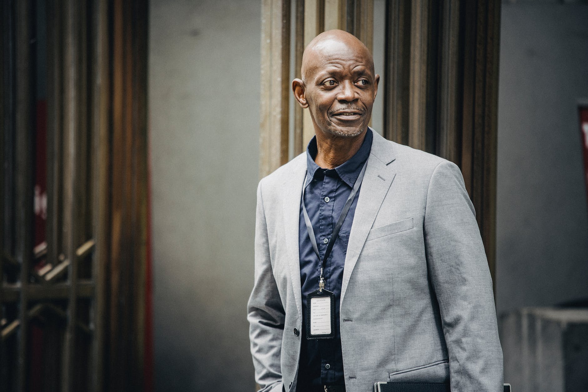 reliable black businessman standing on urban street